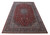 10'3" x 16'7" oversize Kashan rug photographed at an angle showing red field and blue borders