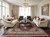 Formal living room styled with a ruby red and ivory 8x11 Mahi rug between cream sofas