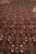 Detail of dense wool and silk pile showing the Herati fish motif in red, ivory and blue