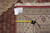 Tape measure and back tag confirming the 8'4 x 11'4 size and Mahi design of this rug