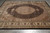 Angled view of ivory medallion, scalloped camel spandrels and dense black herati ground