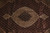 Close-up of the scalloped ivory medallion and pendants over the dense fish pattern ruby field