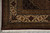 Corner detail of the ivory main border with rosettes, vines and hand-tied white cotton fringe