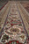 Ivory main border detail with turtle palmettes, curling leaves and rust floral vinework