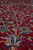 Low angle raking light across soft wool pile showing rosettes, birds and flowering branches