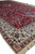 Angled floor view of the 5'2" x 8'3" Nain rug edge, fringe and border