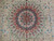 Close-up of the coral and cobalt 16 lobe medallion surrounded by fine vine scroll