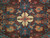 11'8" x 17' Pakistani rug close-up: ivory rosette, apricot blossoms, teal vines on burgundy field