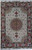 8x12 ivory Persian Tabriz rug photographed flat, coral medallion, green vine borders, wool and silk pile