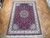 8 x 12 Persian Tabriz wool and silk rug displayed on parquet showroom floor