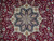 Close-up of navy and ivory 8 point star medallion with rose palmettes on red
