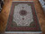 Ivory wool and silk Tabriz rug displayed on parquet floor showing coral border and green guard stripes