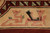 Pair of salmon foo dogs woven into the wide beige outer border