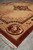 6 by 9 Chinese silk rug photographed from the corner with dragon roundel detail