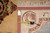 Tape measure and inventory tag PIX 20506 beside the rug back and fringe
