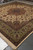 12' x 12'7" Persian Tabriz rug corner showing olive green border and ivory selvedge detail