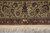 Woven signature cartouche in the outer border above the ivory fringe of this signed rug