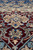 Burgundy corner spandrel detail with sky blue flowers and ivory arabesque in fine weave