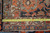 Tape measure laid across the ivory border of the antique Serapi showing tight handmade weave