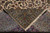 13x20 Persian Kashan rug folded back to show the tight hand-knotted weave and fringe