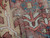 Macro view of low wool pile and cotton foundation showing hand-knotted weave with honest age wear
