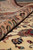 Rolled edge of the Tabriz rug showing plush wool pile depth and peach border flowers