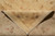 Folded corner revealing even cotton foundation back and fine hand-knotted wool weave