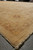 14 x 20 oversize wool rug seen along the fringed end on warehouse floor