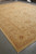 Full length view of the 14' x 19'5" beige gold Pakistani rug from one corner