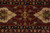 Macro of rust border with ivory cartouche palmettes, olive vines and black guard stripe