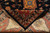 Folded corner revealing cotton foundation, tight knotting and ivory fringe on hand-knotted wool rug