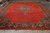 Oversize 12x18 Persian Mahal rug displayed flat on gallery floor showing wide open red field