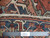 Back of rug with ruler and label confirming authentic handmade knotting on cotton foundation