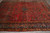 10'8 x 14'6 Sarouk rug angled view showing open red field and deep blue vase border
