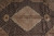 Close-up of beige medallion with rose, olive and blue floral rosettes on black Mahi ground