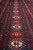 Main border close-up with orange and ivory star rosettes set on a blue ground