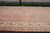 Ivory main border and peach field seen from one end of the oversize rug
