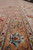 Ivory and peach guard borders running the length of this oversize wool and silk rug