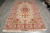 6'7" x 10'3" Persian Tabriz rug photographed flat on grey tile showing full medallion layout