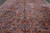 Close field detail with paisley boteh, palmettes and blue vinework on ivory antique Persian rug