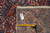 Back of rug with inventory tag and tape measure confirming 11 x 17'4" hand-knotted weave