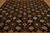 Close overhead of all-over floral field, gold and celadon blossoms scattered across deep black ground