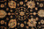 Detail of hand-knotted rosettes, palmettes and curling vines in gold, sage and rust tones