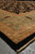 Side perspective of the black floral field meeting green border with dark almond leaf motifs