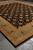 Complete 14x17 oversize black and gold Ziegler design rug photographed at an angle indoors