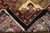 Folded corner revealing the back weave, cotton fringe and knot density of this handmade rug