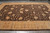 Angled floor view showing chocolate field, gold vines and wide camel border with cypress motifs