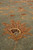 Low angle macro showing thick natural wool pile and a rust palmette in detail