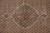 Close-up of lobed medallion with silk outline, side cartouches and dense rust lattice detail