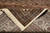 Folded corner showing back of hand-knotted rug, fine knotting and natural ivory cotton fringe